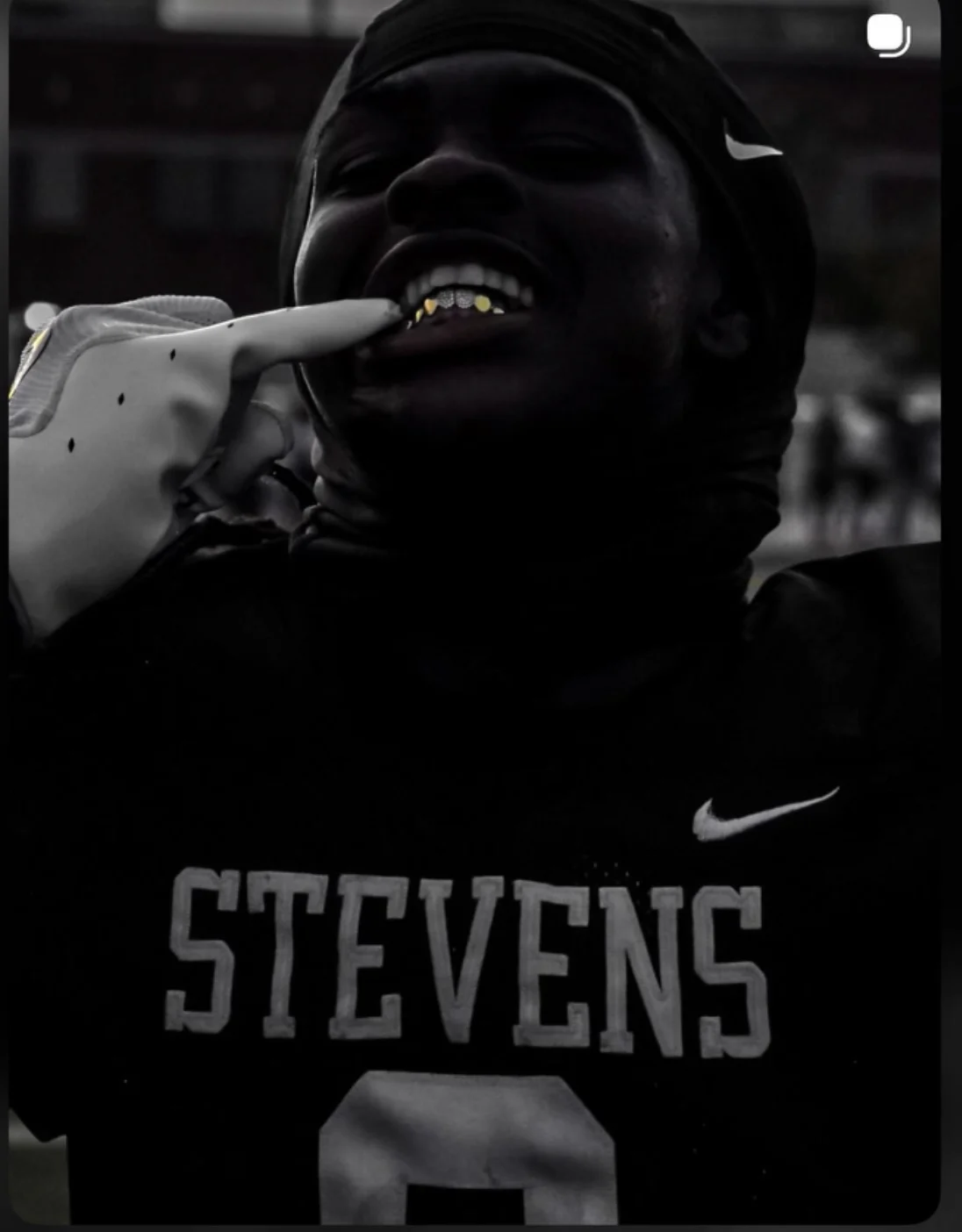 Football player showing his grill in the newly supplied photograph